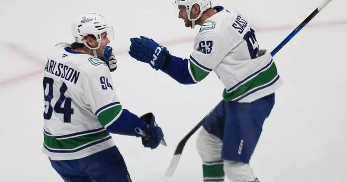 Boeser has hat trick, last-place Canucks overcome blowing 4-goal lead to beat NHL-leading Avs 8-6