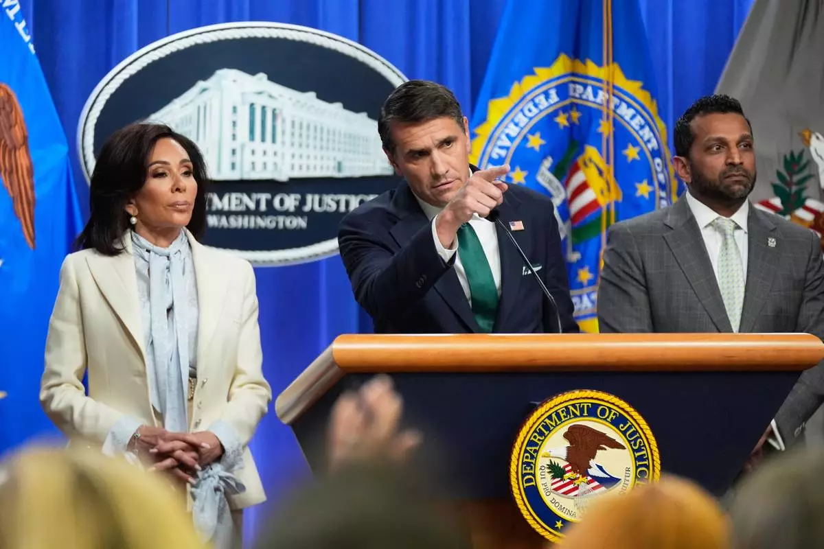 Acting Attorney General Todd Blanche, with U.S. Attorney Jeanine Pirro, left, and FBI Director Kash Patel, right, speaks during a news conference at the Department of Justice, on Monday April 27, 2026, in Washington, following the initial appearance in federal court of the suspected White House Correspondents Dinner gunman, Cole Tomas Allen of Torrance, California. (AP Photo/Manuel Balce Ceneta)