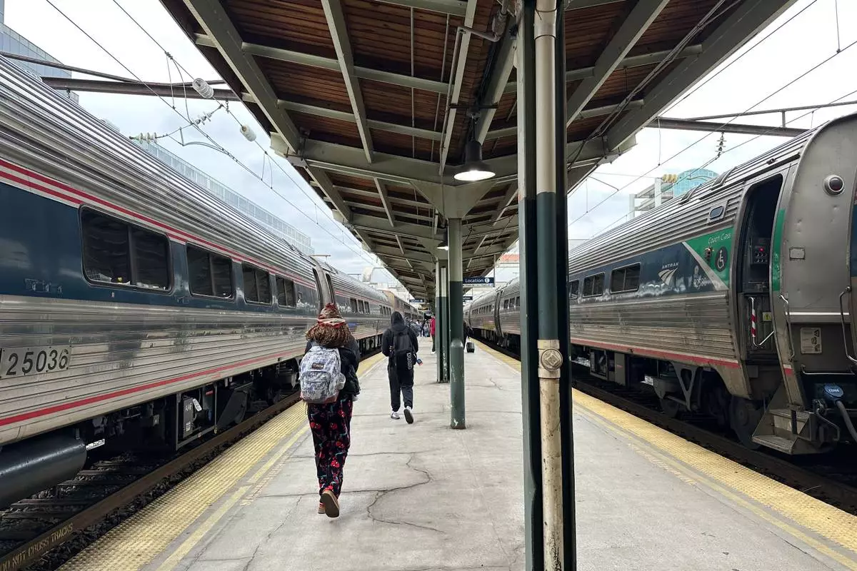 FILE - People walk through Union Station on March 27, 2026, in Washington. (AP Photo/Bill Barrow, File)