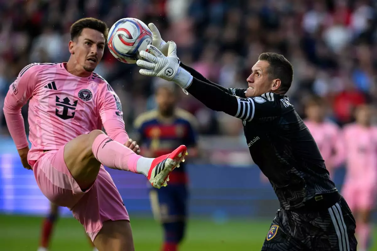 Real Salt Lake goalkeeper Rafael Cabral, right, reaches for the ball as Inter Miami forward Tadeo Allende attempts to kick it during an MLS soccer match, Wednesday, April 22, 2026, in Sandy, Utah. (AP Photo/Tyler Tate)