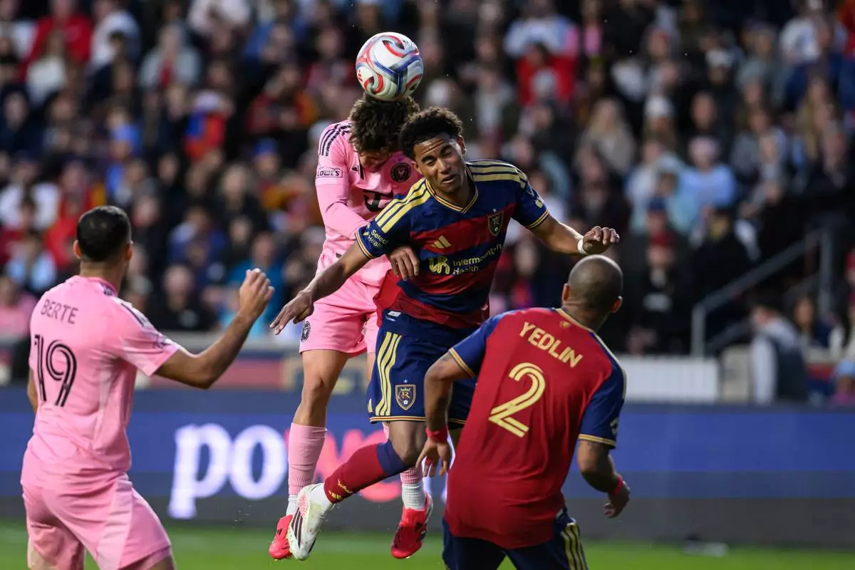 Real Salt Lake midfielder Pablo Ruiz, center right, heads the ball away from Inter Miami defender Sergio Reguilón, center left, during an MLS soccer match, Wednesday, April 22, 2026, in Sandy, Utah. (AP Photo/Tyler Tate)