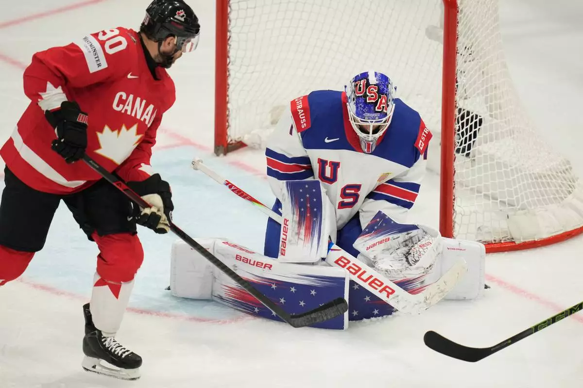 United States' goalkeeper Devin Cooley (1) defends the goal while pressured by Canada's Ryan O'Reilly (90) during the third period of the 2026 IIHF Men's Ice Hockey World Championship quarterfinal match between Canada and United States, in Fribourg, Switzerland, Thursday, May 28, 2026. (AP Photo/Darko Bandic)