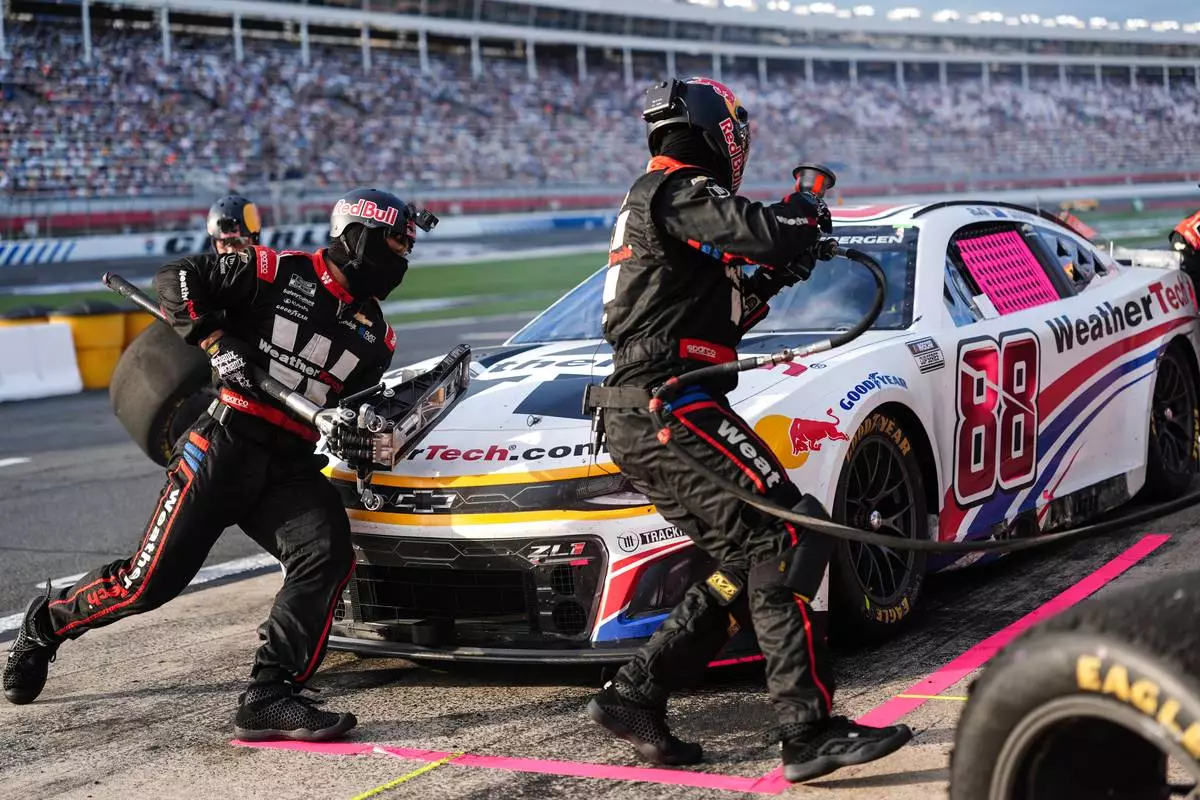 FILE - The pit crew for Shane van Gisbergen (88) rushes to complete a pit stop during a NASCAR Cup Series auto race at Charlotte Motor Speedway, Oct. 5, 2025, in Concord, N.C. (AP Photo/Matt Kelley, File)