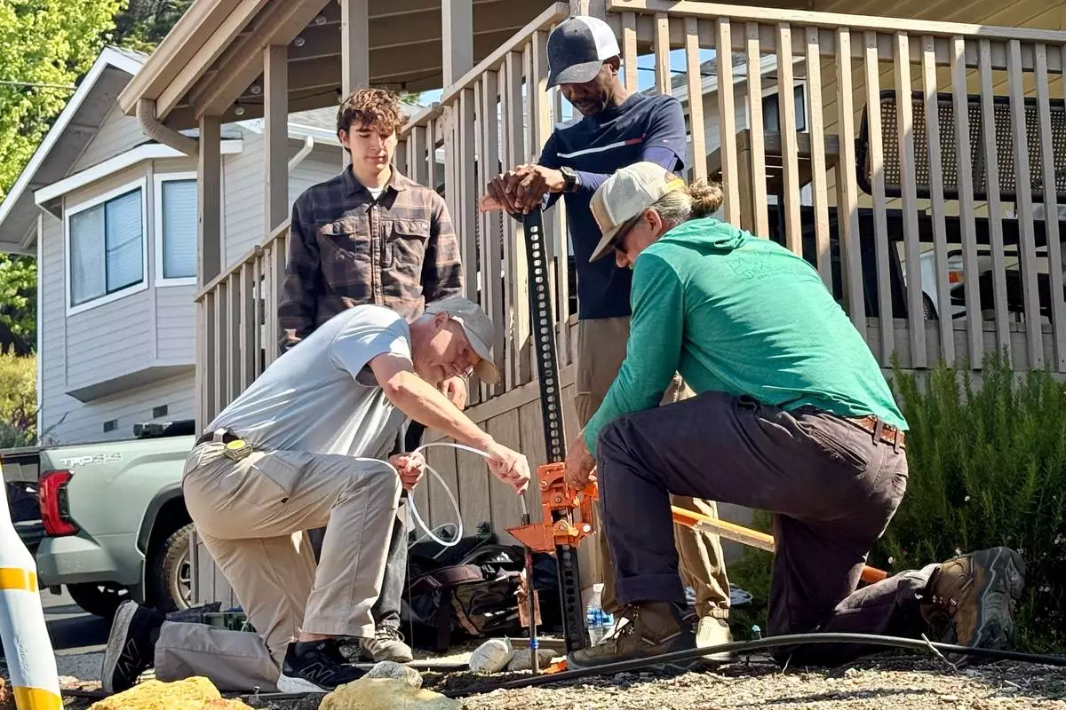 Scientists take samples from the soil Thursday, May 7, 2026, from the neighboring yard of a home in Arroyo Grande, Calif., connected to the man convicted of killing Kristin Smart as part of a sheriff's investigation. (AP Photo/Haven Daley) CORRECTION: Corrects from authorities to scientists