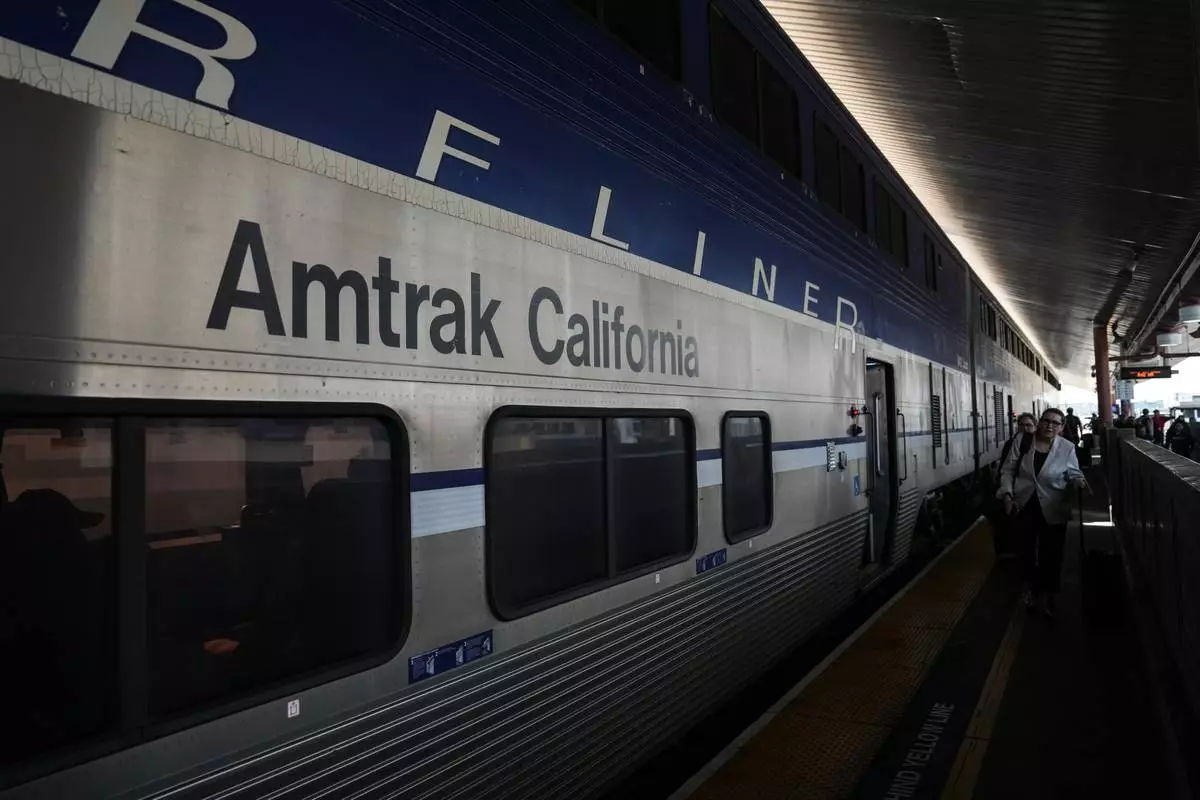 Passengers deboard an Amtrak train at Union Station in Los Angeles, Thursday, April 30, 2026. (AP Photo/Jae C. Hong)