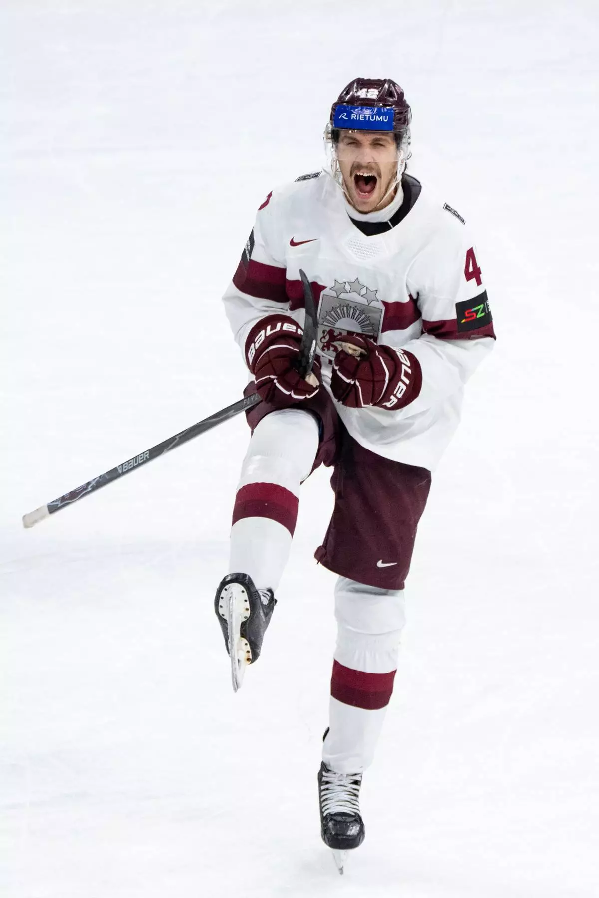 Latvia's Kristofers Bindulis celebrates after scoring the fifth goal during the 2026 IIHF Men's Ice Hockey World Championship preliminary round group A game between Hungary and Latvia, in Zurich, Switzerland, Tuesday, May 26, 2026. (Claudio Thoma/Keystone via AP)