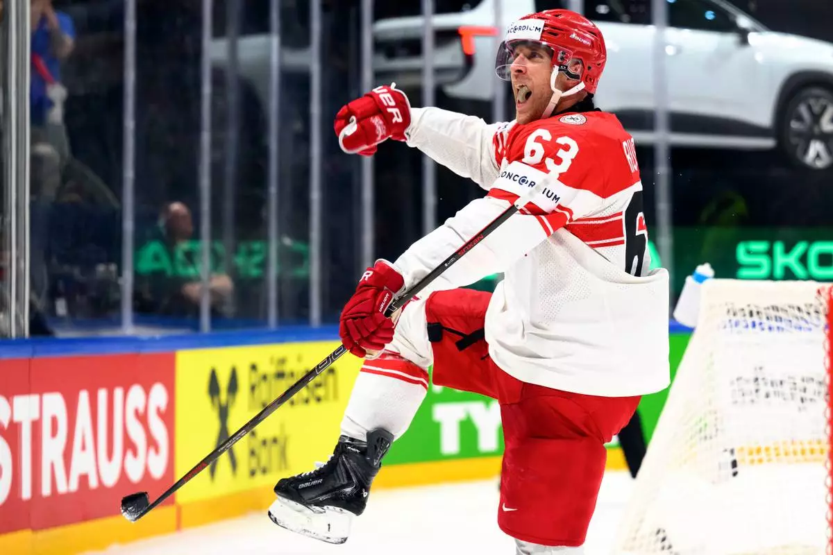 Denmark's Patrick Russell celebrates after scoring his side's third goal during the 2026 IIHF Men's Ice Hockey World Championship preliminary round group B match between Norway and Denmark in Fribourg, Switzerland, Tuesday, May 26, 2026. (Laurent Gillieron/Keystone via AP)