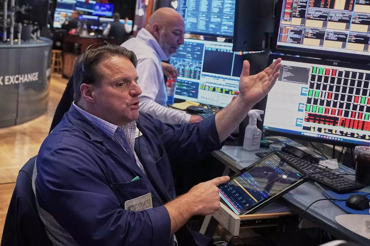 Trader Michael Milano, foreground works on the floor of the New York Stock Exchange, Friday, May 1, 2026. (AP Photo/Richard Drew)