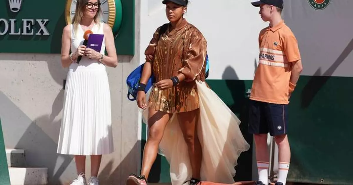 Naomi Osaka's latest French Open fashion ensemble includes an ivory train and gold jacket