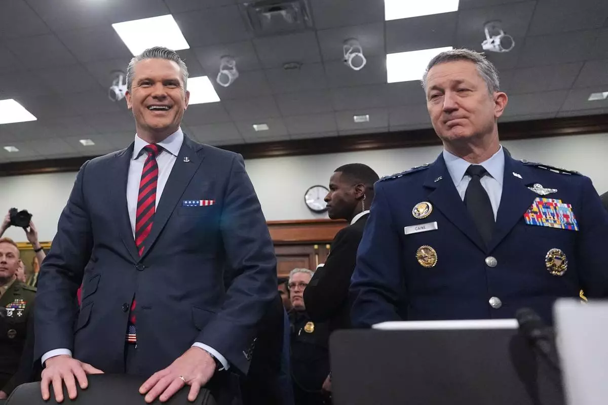 Defense Secretary Pete Hegseth and Chairman of the Joint Chiefs of Staff Gen. Dan Caine arrive to testify at a House Appropriations subcommittee budget hearing for the Department of Defense, Tuesday, May 12, 2026, in Washington. (AP Photo/Alex Brandon)