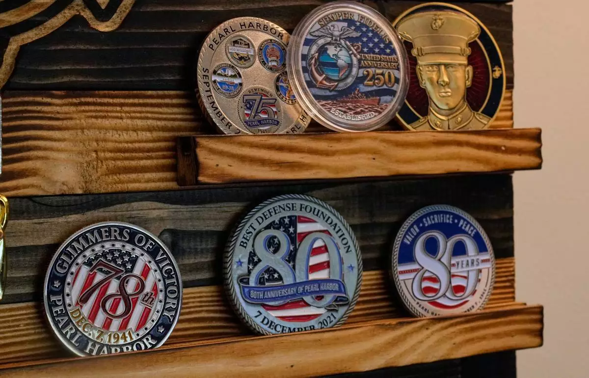 A collection of challenge coins is on display in Pearl Harbor survivor Freeman K. Johnson's home, May 6, 2026, in Centerville, Mass. (AP Photo/Charles Krupa)