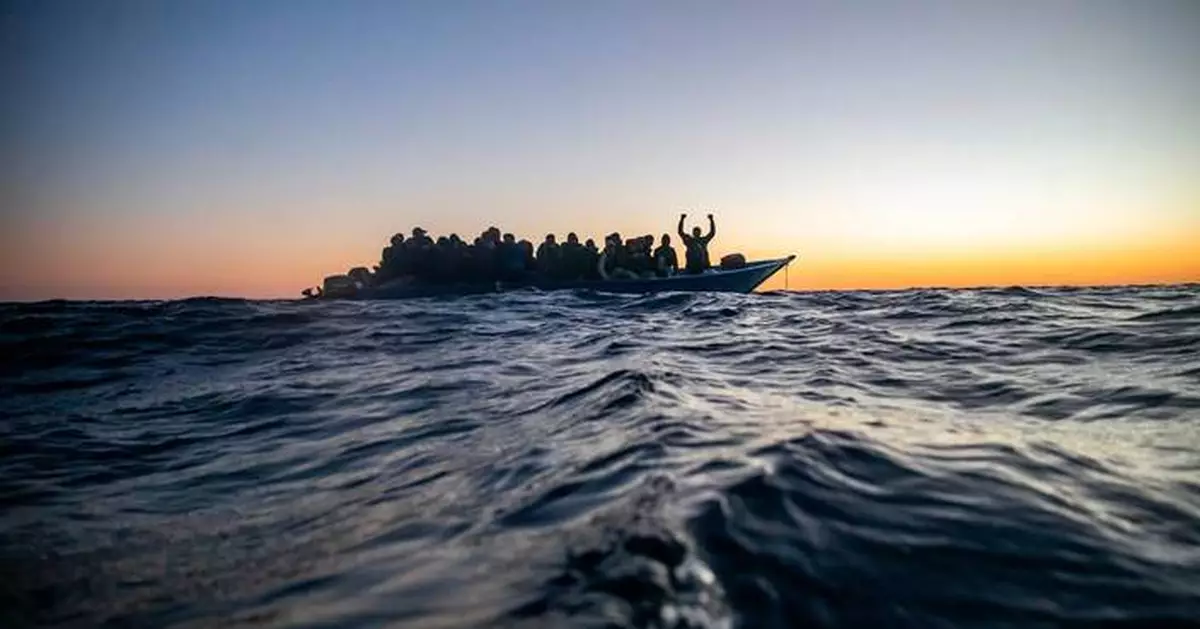 Aid group says Libyan-linked vessels fired on a migrant rescue ship in the Mediterranean