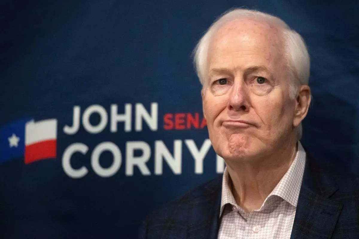 Sen. John Cornyn, R-Texas, listens to State Sen. Charles Perry, R-Lubbock, during a campaign event in Lubbock, Texas, Tuesday, May 19, 2026. (AP Photo/Annie Rice)