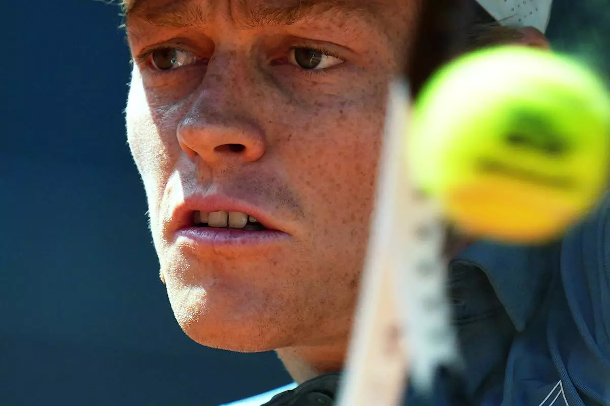 Italy's Jannik Sinner returns the ball to France's Arthur Fils during their men's singles semifinal match at the Madrid Open tennis tournament in Madrid, Spain, Friday, May 1, 2026. (AP Photo/Manu Fernandez)