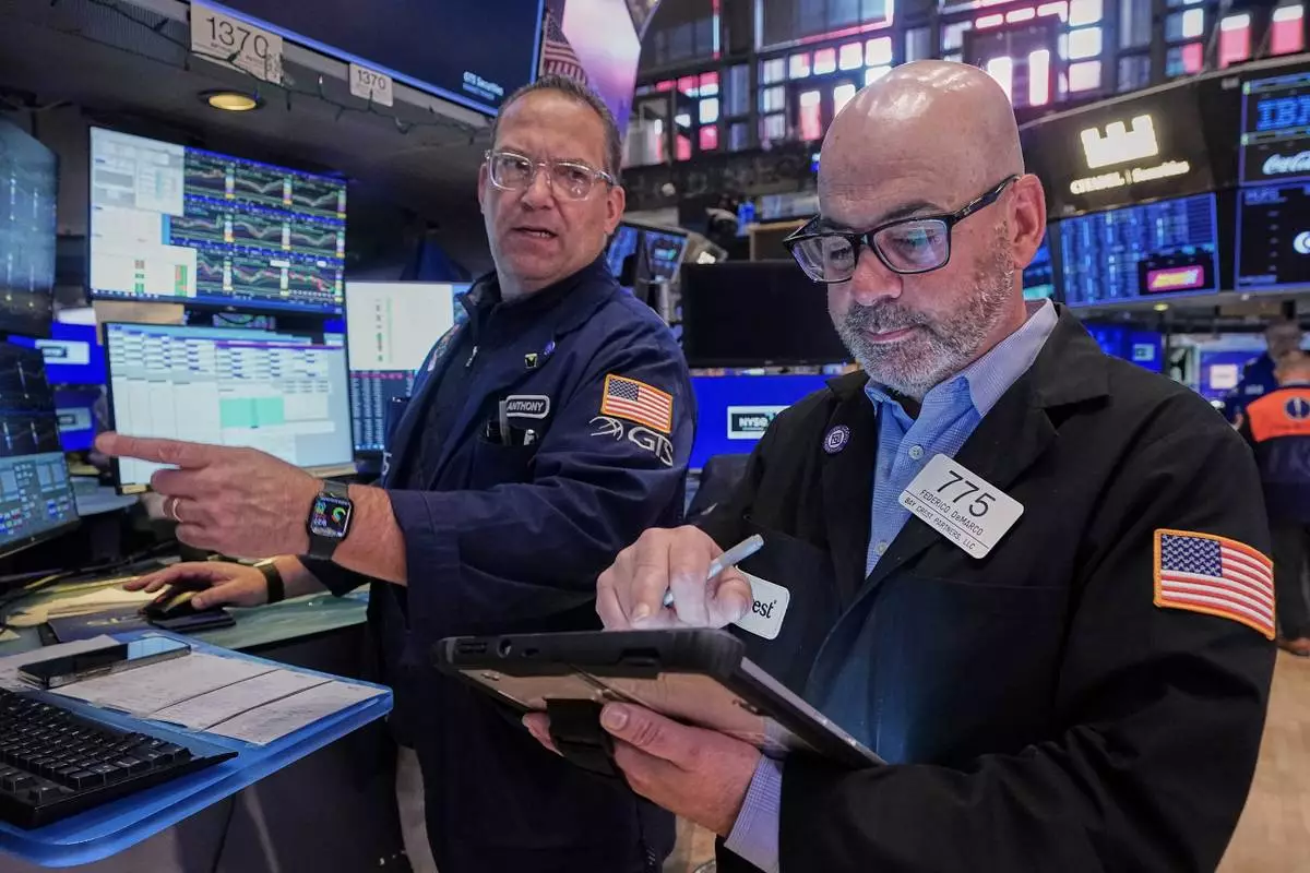 Specialist Anthony Matesic, left, and trader Fred Demarco work on the floor of the New York Stock Exchange, Friday, May 22, 2026. (AP Photo/Richard Drew)