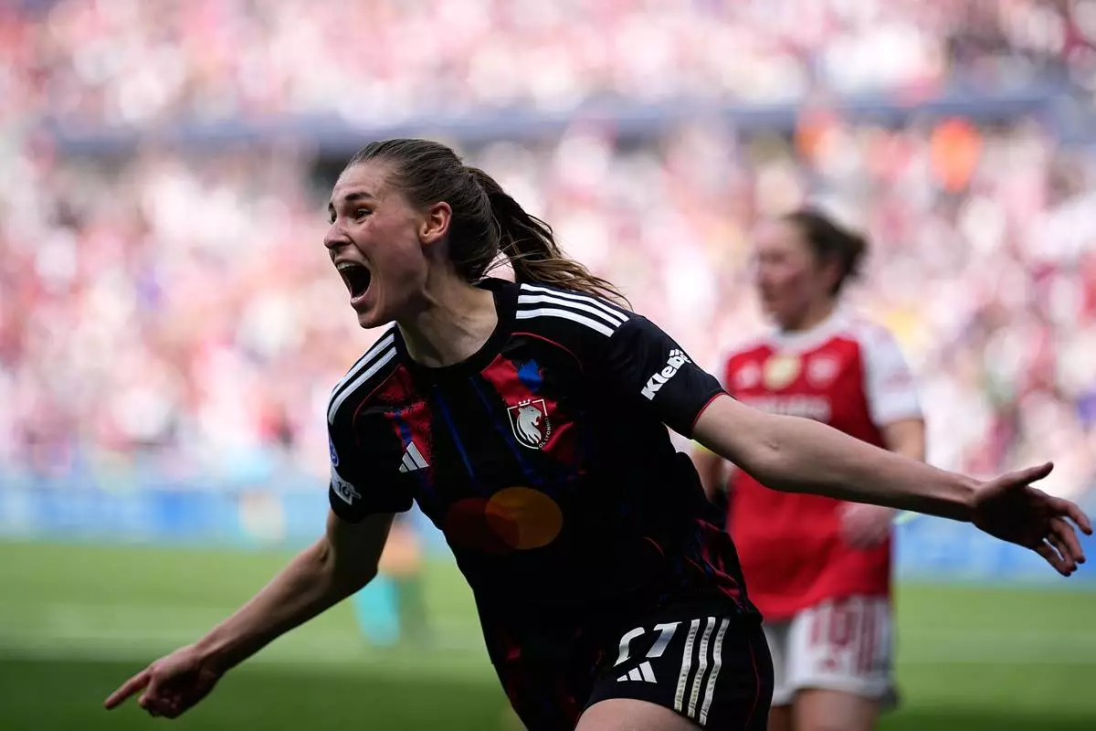 Lyonnes' Jule Brand celebrates after scoring her side's third goal during the Women's Champions League semifinal, second leg, soccer match between OL Lyonnes and Arsenal, in Decines, outside Lyon, France, Saturday, May 2, 2026. (AP Photo/Laurent Cipriani)