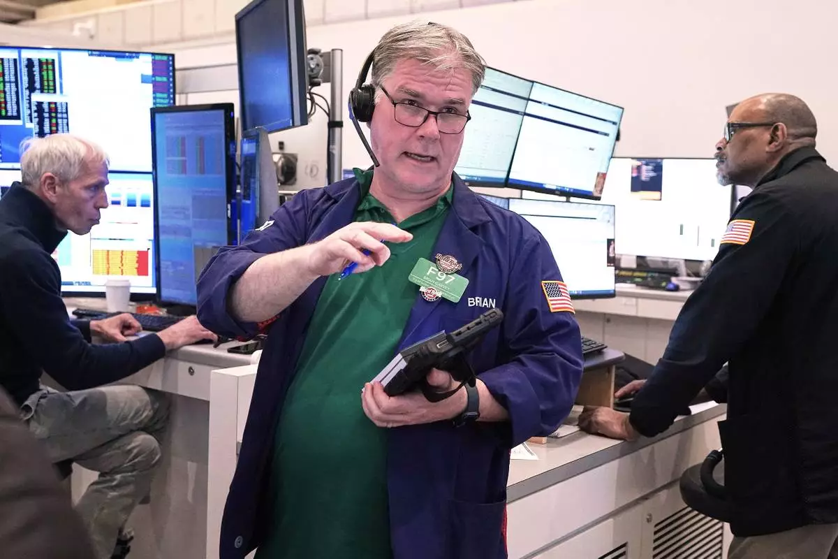 Options trader Brian Garvey, center, works on the floor of the New York Stock Exchange, Monday, May 11, 2026. (AP Photo/Richard Drew)