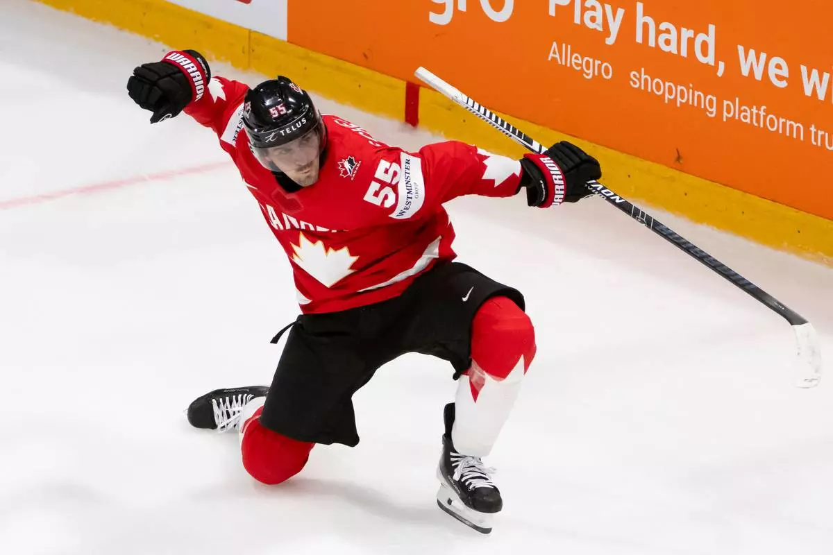 Canada's Mark Scheifele celebrates the winning goal in overtime of the 2026 IIHF Men's Ice Hockey World Championship preliminary round group B game between Canada and Norway, in Fribourg, Switzerland, Thursday, May 21, 2026. (Anthony Anex/Keystone via AP)