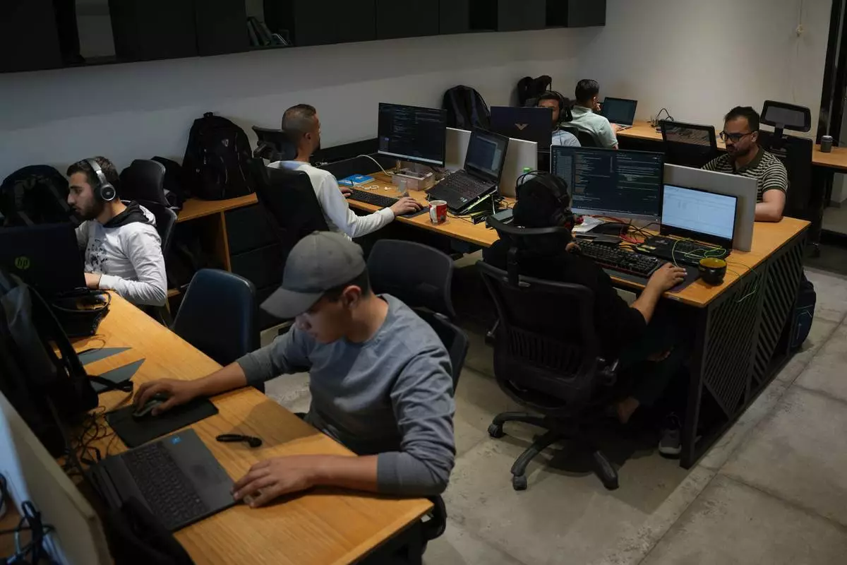 Palestinian digital freelancers work on projects for clients abroad at a coworking space in Gaza City, Tuesday, May 12, 2026. (AP Photo/Abdel Kareem Hana)