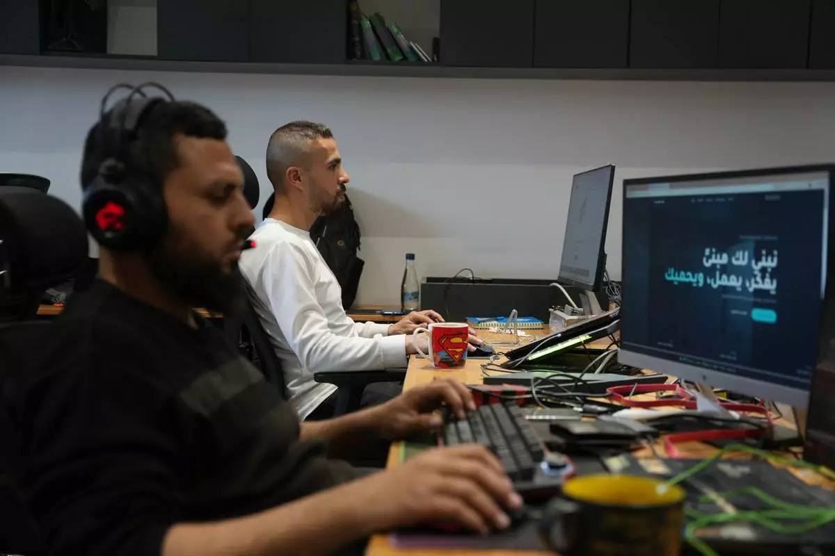 Palestinian digital freelancers work on projects for clients abroad at a coworking space in Gaza City, Tuesday, May 12, 2026. (AP Photo/Abdel Kareem Hana)