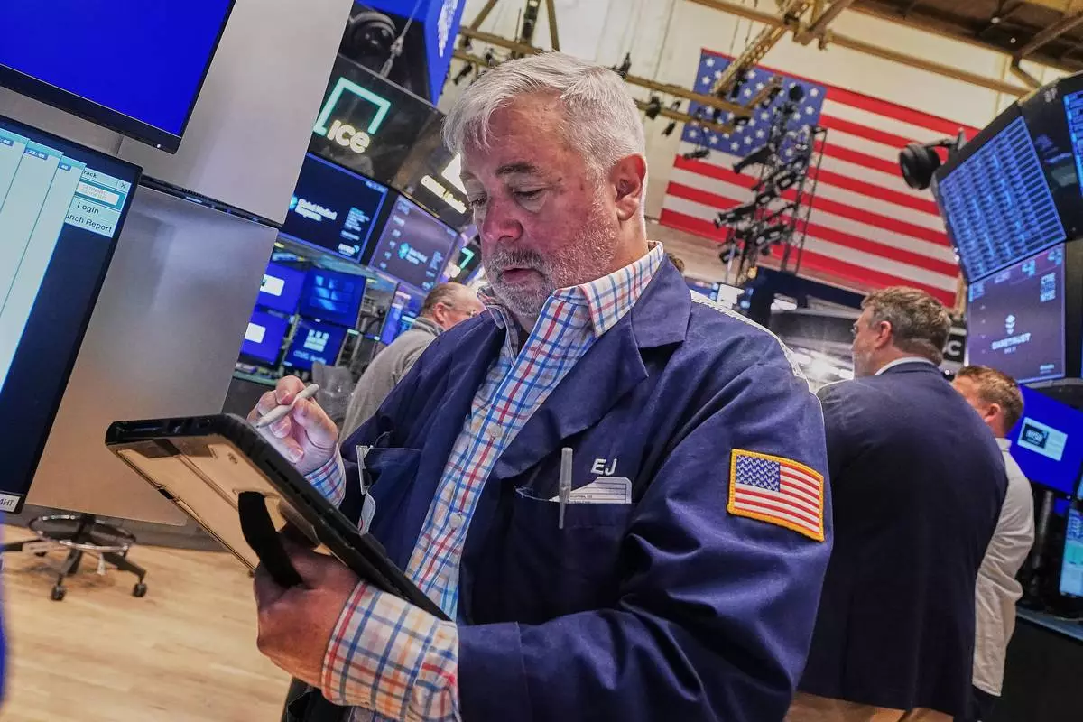 Trader Edward McCarthy works on the floor of the New York Stock Exchange, Wednesday, May 13, 2026. (AP Photo/Richard Drew)