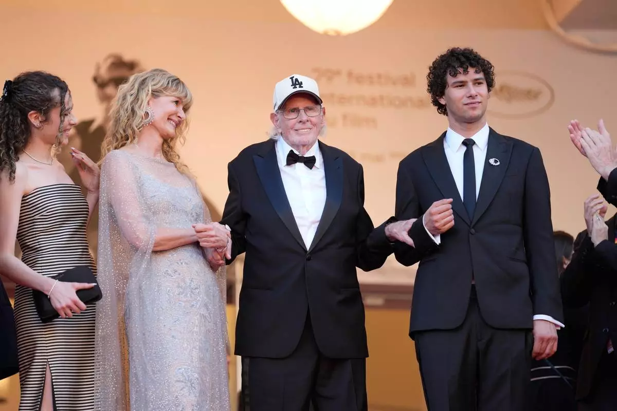 Jaya Harper, from left, Laura Dern, Bruce Dern, and Ellery Harper pose for photographers upon arrival at the premiere of the film 'De Gaulle: Tilting Iron' at the 79th international film festival, Cannes, southern France, Wednesday, May 20, 2026. (AP Photo/John Locher)