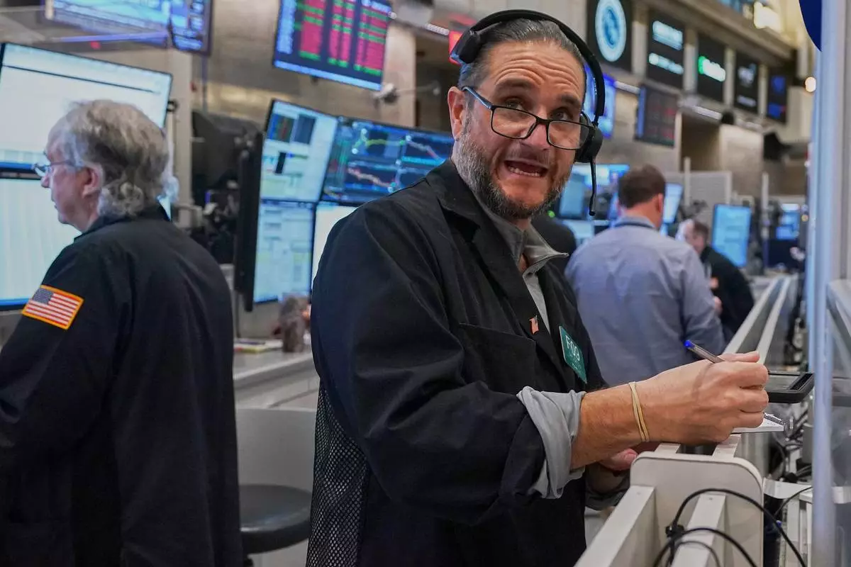 Options trader Chris Dattolo works on the floor of the New York Stock Exchange, Wednesday, May 13, 2026. (AP Photo/Richard Drew)