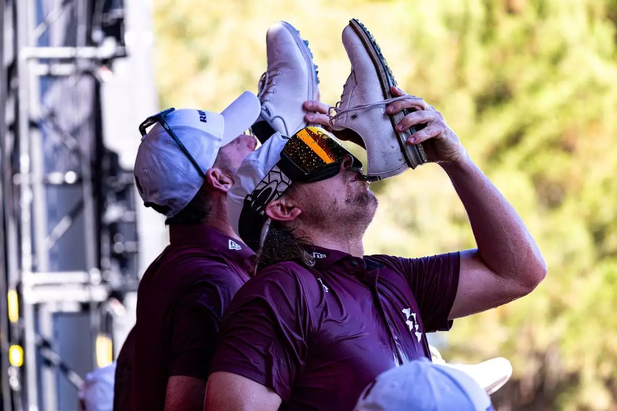 FILE - Ripper GC golfers drink champagne from their shoes after winning the First Place Team Champions at the Trophy Ceremony during the final round of the LIV Golf Adelaide at Grange Golf Club, Feb. 15, 2026, in Adelaide, Australia. (Jon Ferrey/LIV Golf via AP, File)