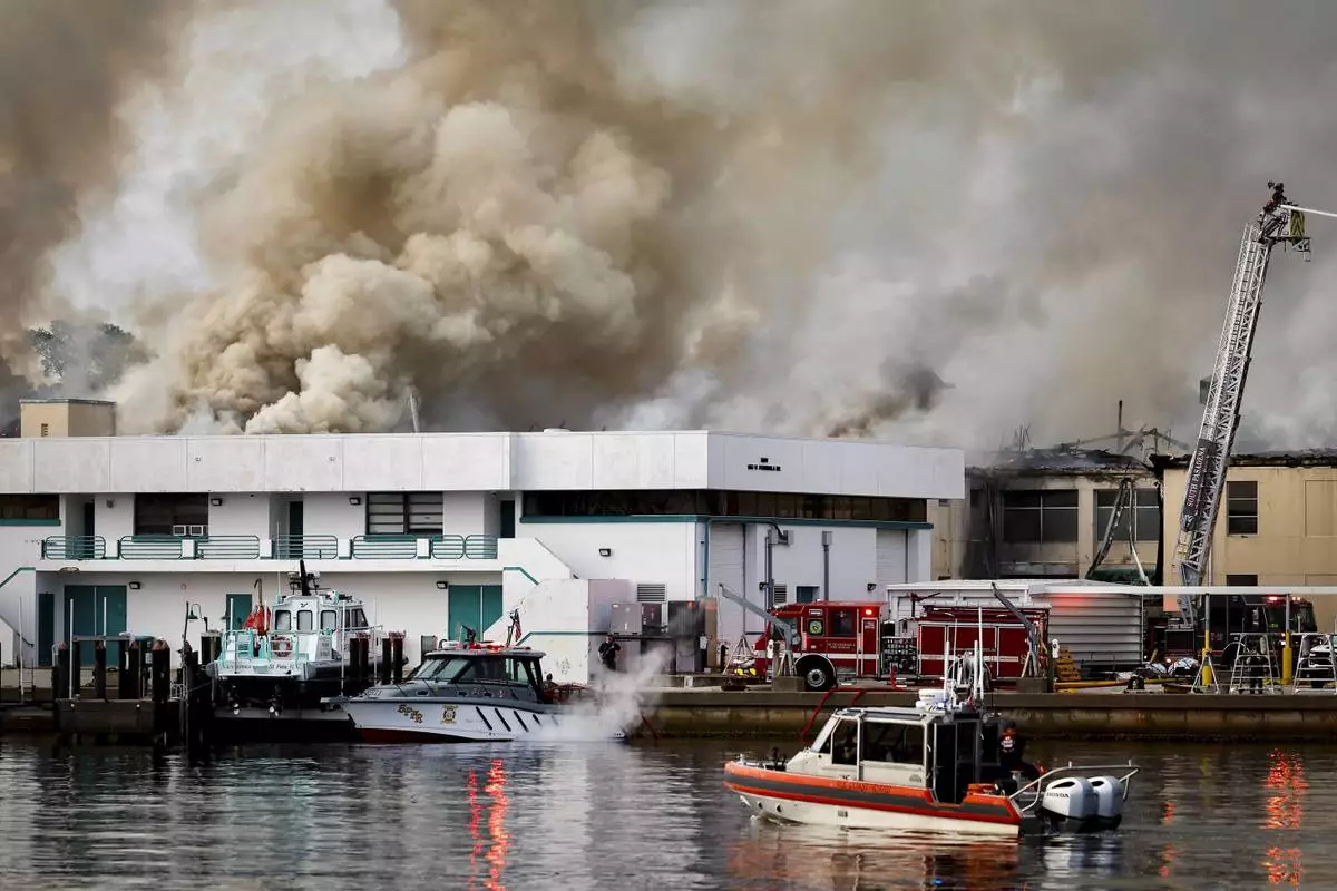 First responders work to extinguish a fire at the University of South Florida campus Saturday, May 2, 2026, in St. Petersburg, Fla. (Luis Santana/Tampa Bay Times via AP)