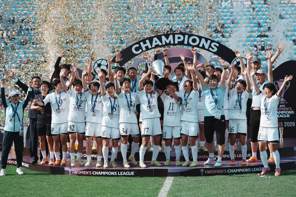 Naegohyang Women's FC's players celebrate on the podium after winning the AFC Women's Champions League soccer final match against Tokyo Verdy Beleza in Suwon, South Korea, Saturday, May 23, 2026. (AP Photo/Lee Jin-man)
