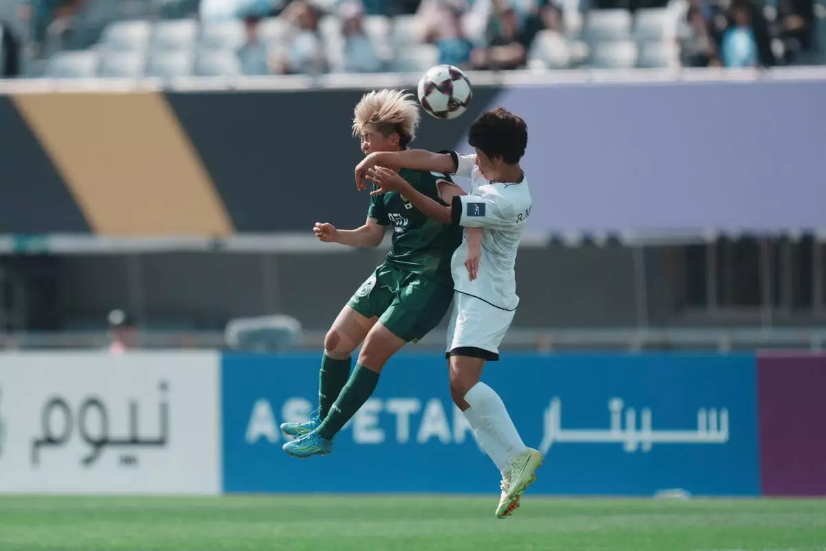 Tokyo Verdy Beleza's Rihona Ujihara, left, battles for the ball against Naegohyang Women's FC's Ri Myong Gum during the AFC Women's Champions League soccer final match in Suwon, South Korea, Saturday, May 23, 2026. (AP Photo/Lee Jin-man)