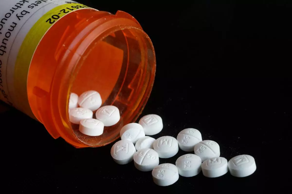 FILE - Pills spill in an arrangement photo of prescription Oxycodone in New York. (AP Photo/Mark Lennihan, File)