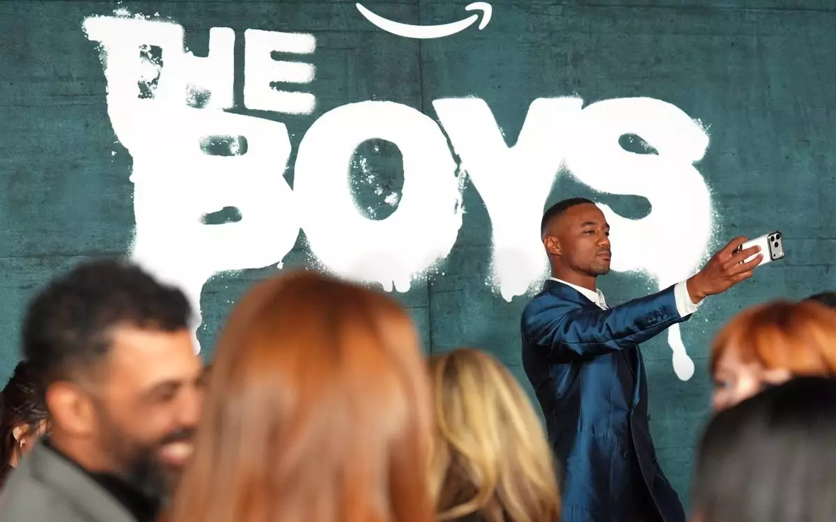 Actor Jessie T. Usher shoots a selfie at the premiere of the series finale of the fifth season of the Amazon Prime Video series "The Boys" on Tuesday, May 19, 2026, in Los Angeles. (AP Photo/Chris Pizzello)