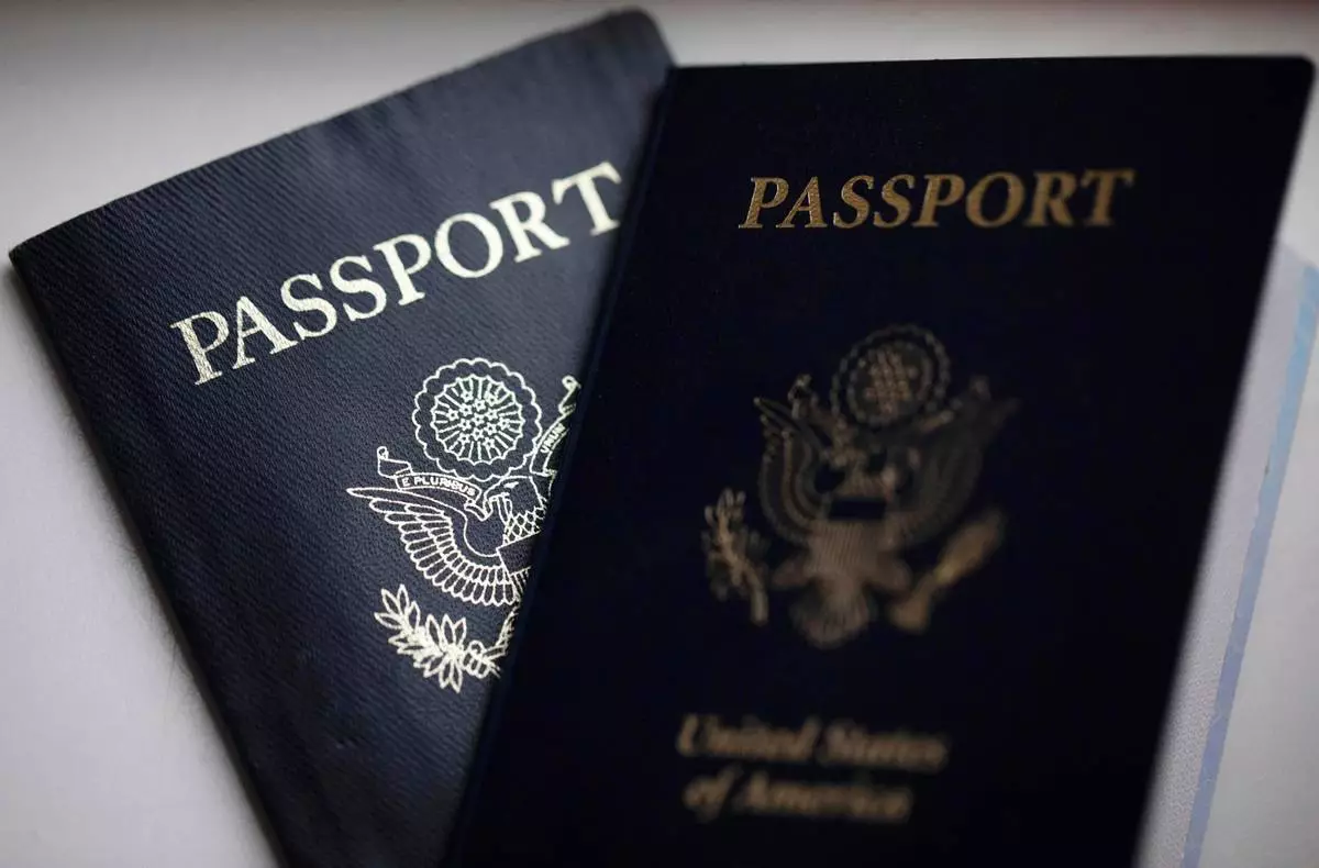 FILE - U.S. passports are arranged for a photograph in Tigard, Ore., Dec. 11, 2021. (AP Photo/Jenny Kane, File)