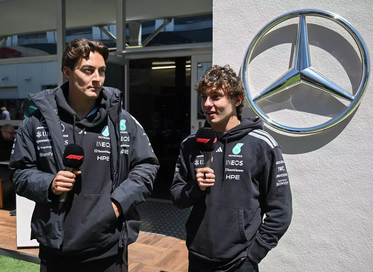 Mercedes drivers George Russell of Britain, left, and Kimi Antonelli of Italy speak during an interview in the paddocks at the F1 Canadian Grand Prix auto race in Montreal, Thursday, May 21, 2026. (Graham Hughes/The Canadian Press via AP)
