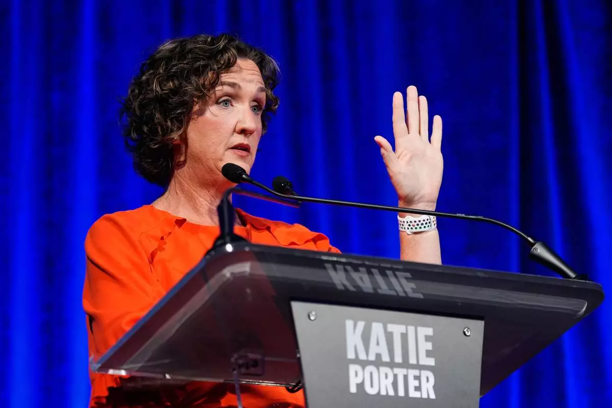 Katie Porter raises her hand during a California gubernatorial debate hosted by CBS Bay Area and the San Francisco Examiner in San Francisco, Thursday, May 14, 2026. (AP Photo/Godofredo A. Vásquez, Pool)