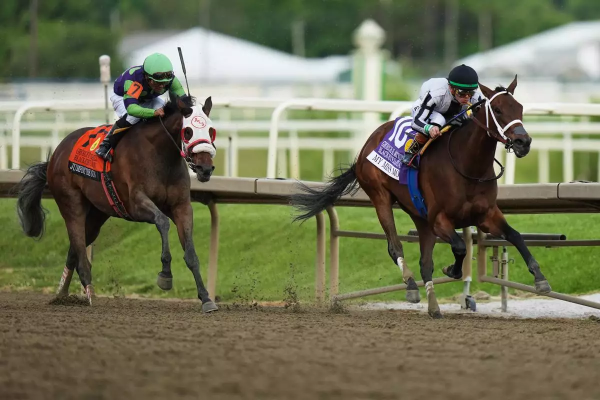 Tyler Gaffalione, right, atop My Miss Mo, edges out Luis Saez, atop Jumping the Gun, to take the lead during the 102nd running of the Black-Eyed Susan horse race, Friday, May 15, 2026, at Laurel Park in Laurel, Md. (AP Photo/Stephanie Scarbrough)