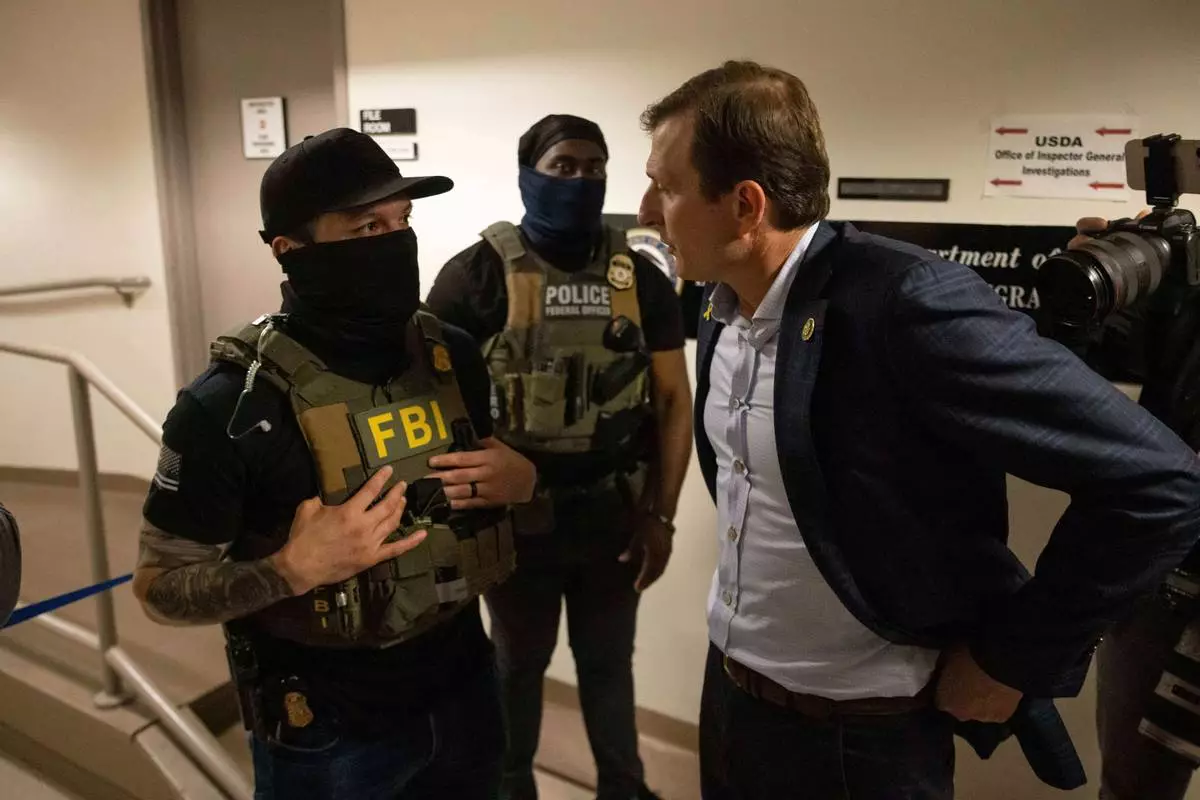 FILE - Rep. Dan Goldman, D-N.Y., left, speaks to the federal agents at the Jacob K. Javits federal building, June 18, 2025, in New York. (AP Photo/Yuki Iwamura, File)