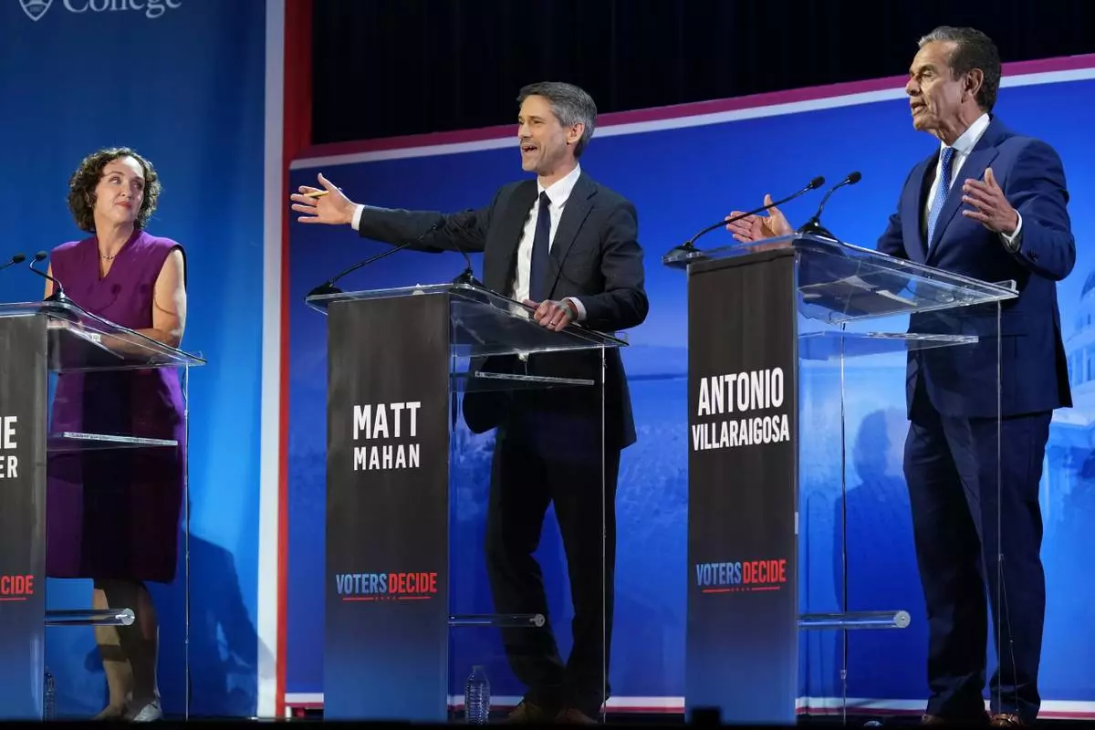 Antonio Villaraigosa, right, and Matt Mahan speak during a California gubernatorial debate hosted by CBS LA at Pomona College in Claremont, Calif., Tuesday, April 28, 2026. (AP Photo/Jae C. Hong)