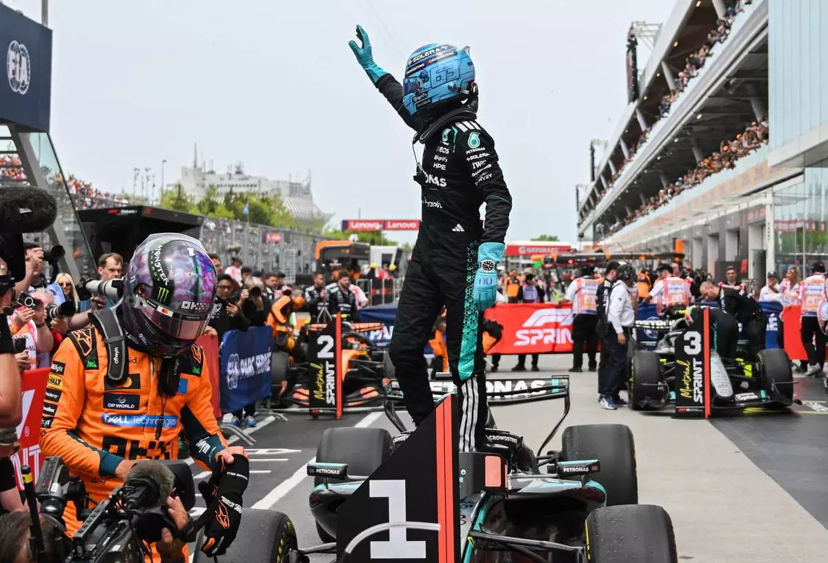 Mercedes driver George Russell, of Britain, waves after winning the sprint race at the F1 Canadian Grand Prix auto race in Montreal, Saturday, May 23, 2026. (Graham Hughes/The Canadian Press via AP)