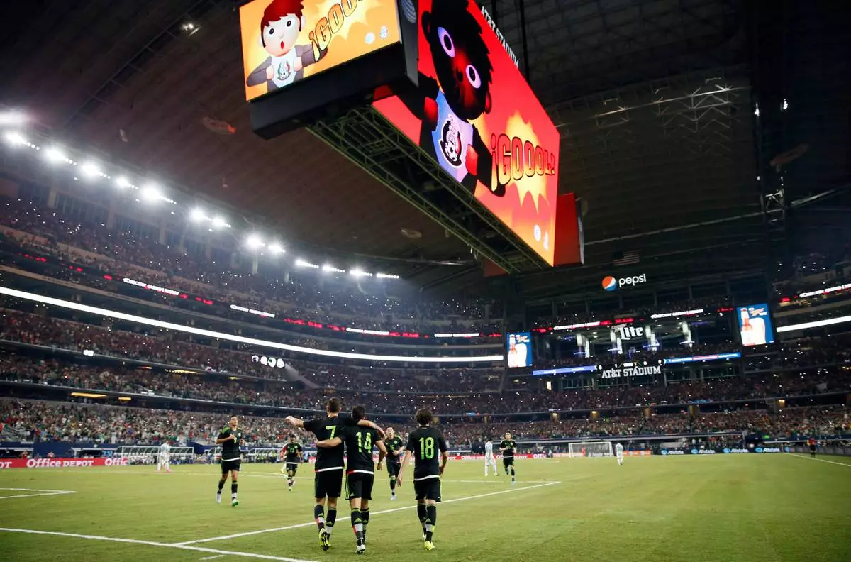FILE - Mexico's Javier Hernandez (14) celebrates with teammates after scoring a penalty kick during a friendly soccer match against Argentina at the AT&amp;T Stadium in Arlington, Texas, Sept. 8, 2015. (AP Photo/Tony Gutierrez, File)
