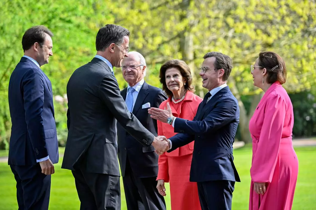 NATO Secretary General Mark Rutte, second from left, shakes hands with Prime Minister of Sweden Ulf Kristersson, as he is greeted by King Carl Gustaf of Sweden, Queen Silvia of Sweden and Minister for Foreign Affairs of Sweden Maria Malmer Stenergard, right, before a dinner at Sofiero Castle in Helsingborg, Sweden, Thursday May 21 2026. (Johan Nilsson/TT News Agency via AP)