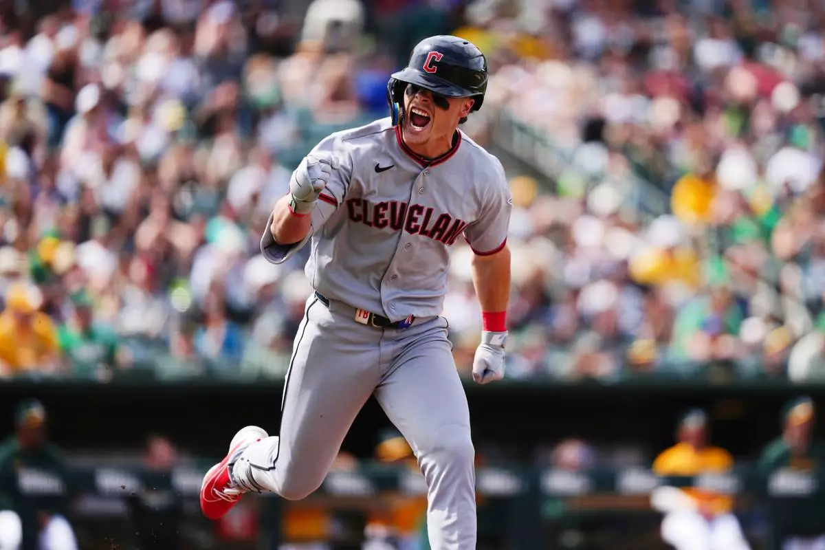 Cleveland Guardians' Travis Bazzana reacts as he runs to first base after hitting his first major league hit, a two-RBI single, in the seventh inning of a baseball game against the Athletics, Saturday, May 2, 2026, in West Sacramento, Calif. (AP Photo/Alan Greth) CORRECTION: Corrects to two-run single not two-run double.