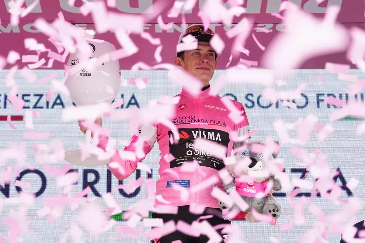 Denmark's Jonas Vingegaard wears the pink jersey of the race overall leader following stage 17 of the Giro d'Italia cycling race from Cassano D'Adda to Andalo, Italy, Wednesday, May 27, 2026. (Gianmattia D'Albertoi/LaPresse via AP) CORRECTION: race title corrected to overall leader only instead of him winning 17th stage