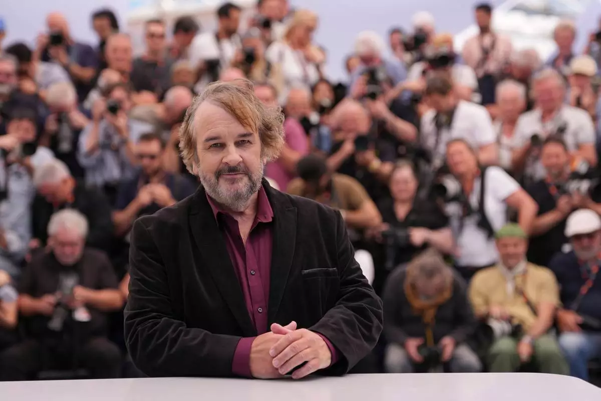 Peter Jackson, recipient of the honorary Palme d'Or, poses for photographers during a photo call at the 79th international film festival, Cannes, southern France, Tuesday, May 12, 2026. (AP Photo/Andreea Alexandru)