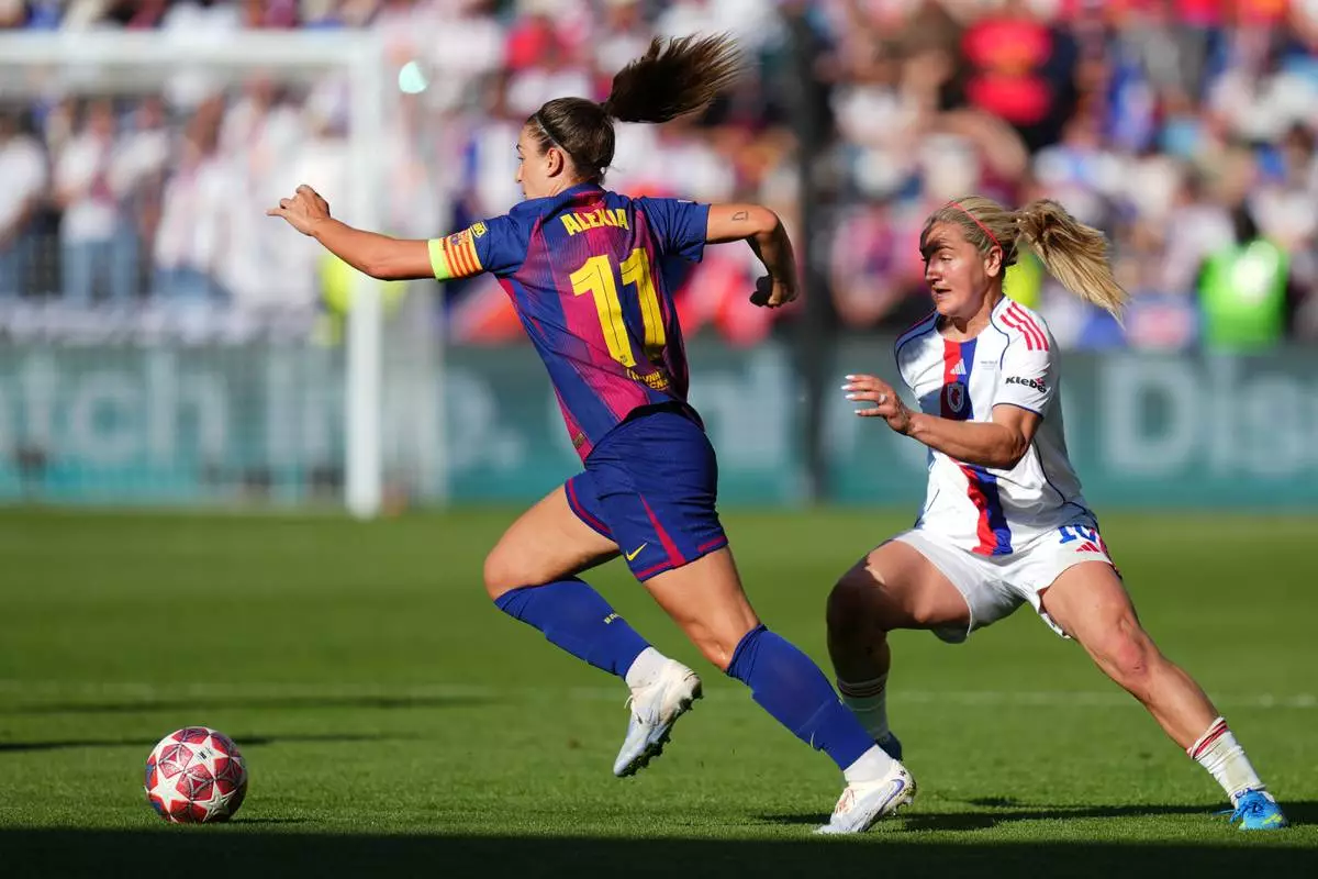 Barcelona's Alexia Putellas runs with the ball away from Lyonnes' Lindsey Heaps, right, during the Women's Champions League final soccer match between FC Barcelona and OL Lyonnes, in Oslo, Saturday, May 23, 2026. (AP Photo/Kirsty Wigglesworth)