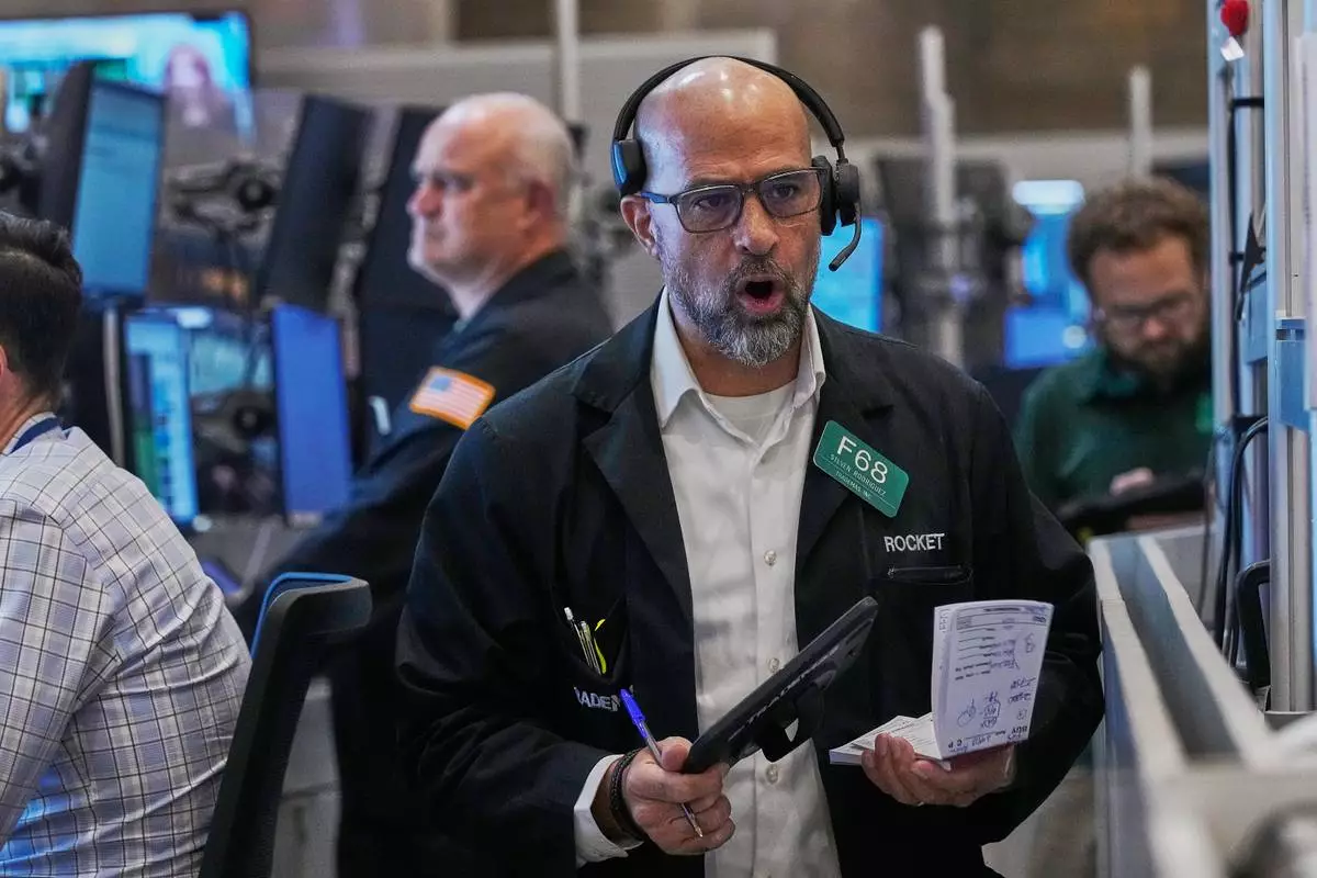 Options trader Steven Rodriguez, center, works on the floor of the New York Stock Exchange, Friday, May 29, 2026. (AP Photo/Richard Drew)