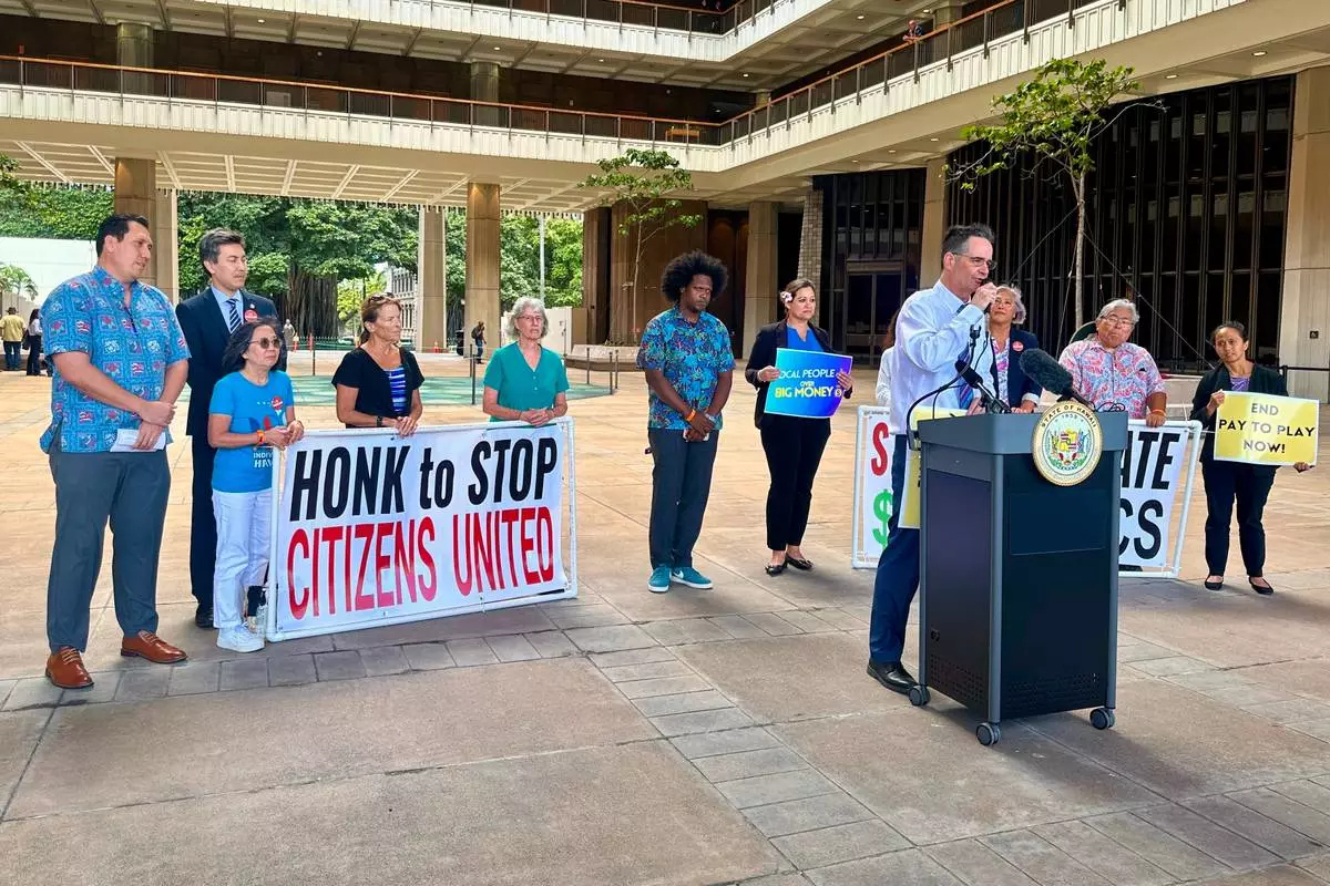 Hawaii Sen. Karl Rhoads speaks at a news conference about a bill that seeks to limit corporate money in politics in Honolulu on Thursday, April 23, 2026 (AP Photo/Jennifer Sinco Kelleher)