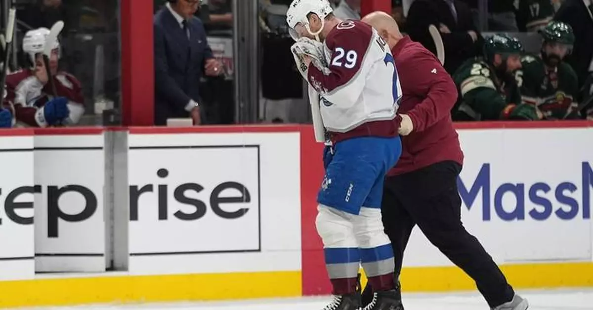 MacKinnon takes a puck from an Avs teammate to the face