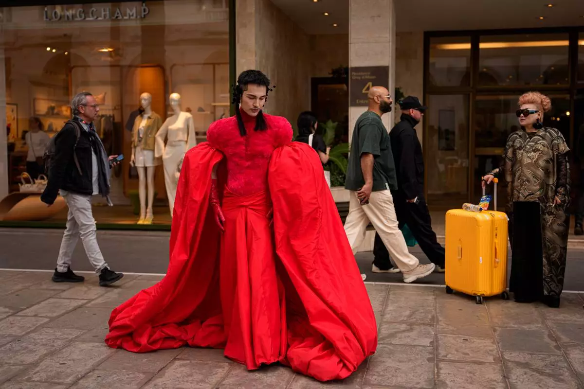 Chen Foye poses for a photograph outside a hotel after walking on the red carpet for the movie "Parallel Talles" during the 79th international film festival, Cannes, southern France, Thursday, May 14, 2026. (AP Photo/Andreea Alexandru)